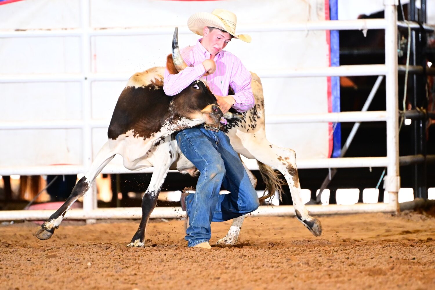 Dyllon Richardson, 14, wrestles a steer for the chute dogging competition.