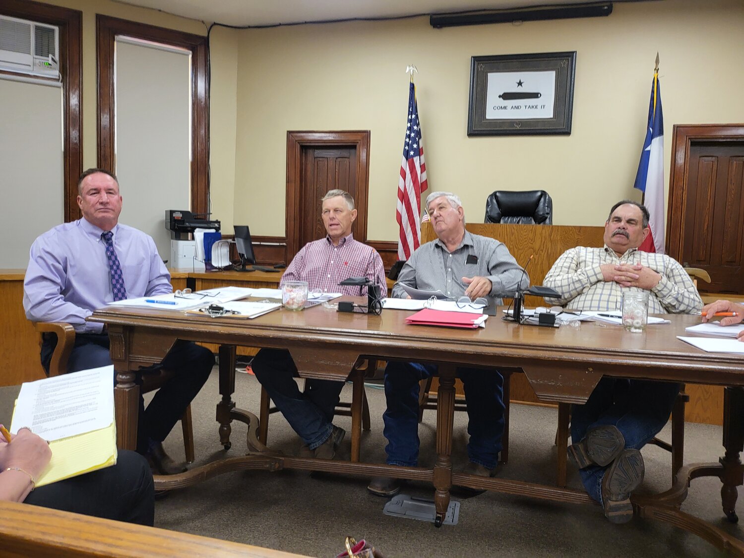 The Gonzales County Commissioners Court listens to VCS representative Anita Scoggins discuss her protest of the county's bidding process on an emergency tower project.