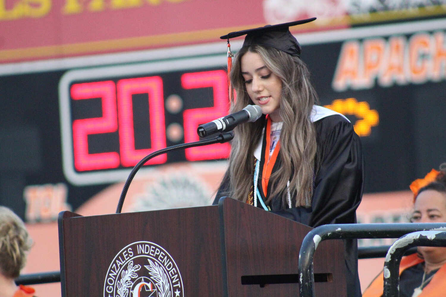 Senior Ainsley Holub gives the valedictorian speech for the Gonzales High School graduating class of 2024 at Apache Field Friday, May 24.