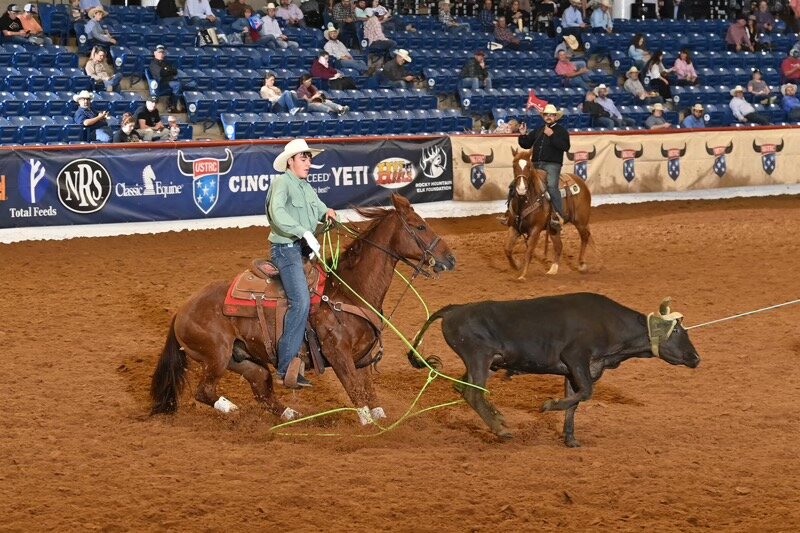 Briggs Hand rope ties a steer for the team roping competition at the Texas High School Rodeo.