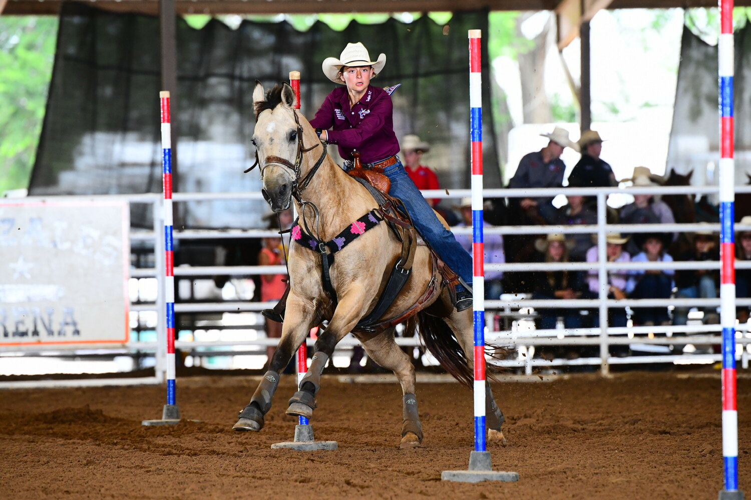 Audrey Thibodeaux moves in between the poles for the pole bending competition of the Texas High School Rodeo.