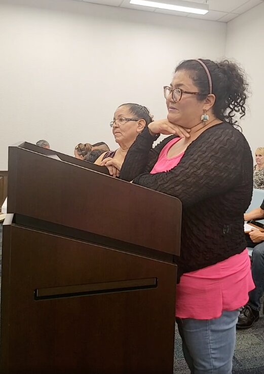 Sandra Flores (front) speaks on behalf of her mother, Irma Flores, as they ask the council to consider lowering the permit fees for food trucks. Nixon charges $225 per month for food truck permits, much higher than a number of neighboring cities.