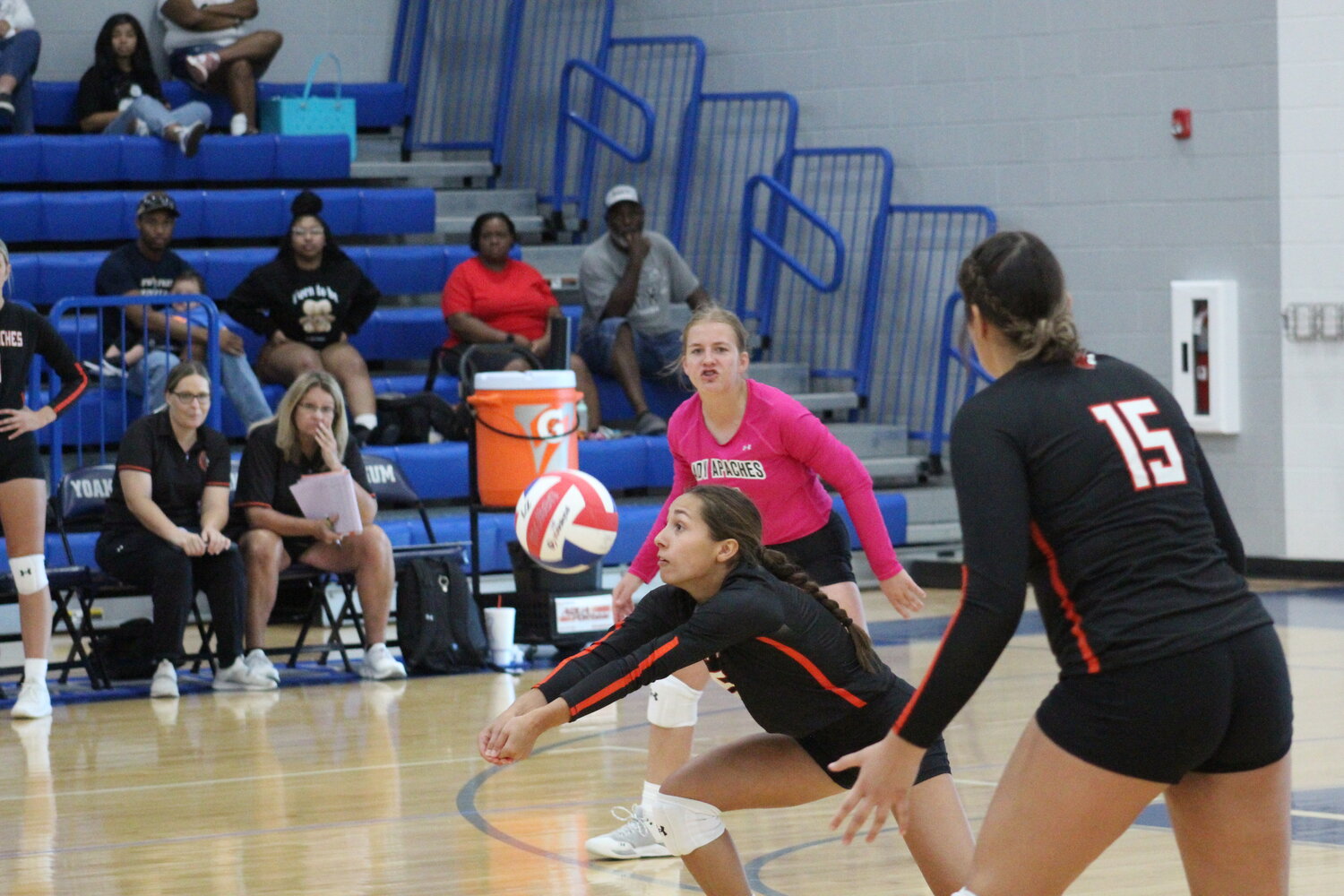 Lady Apaches sophomore middle blocker Jordyn Gonzales (5) hits the ball in the air in the season opener against Yoakum and Shiner Tuesday, Aug. 13.