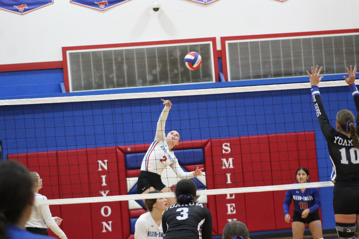 Lady Mustangs senior Hailee Houseton (2) spikes the ball in the air in the Yoakum match Tuesday, Sept. 3.