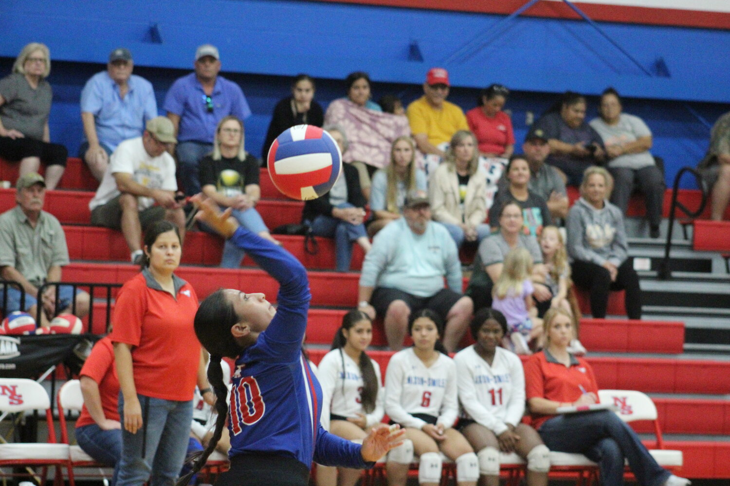 Lady Mustangs senior libero Emily Granados (10) serves the ball against the Yorktown Kitty Kats Tuesday, Sept. 17.