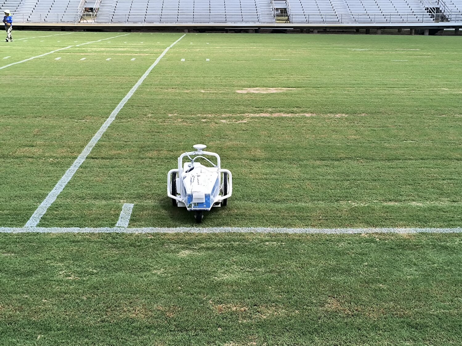 The Gonzales ISD maintenance crew remote controls a yard line spray Tuesday, Sept.17 in preparations for Friday’s home opener against Pleasanton.