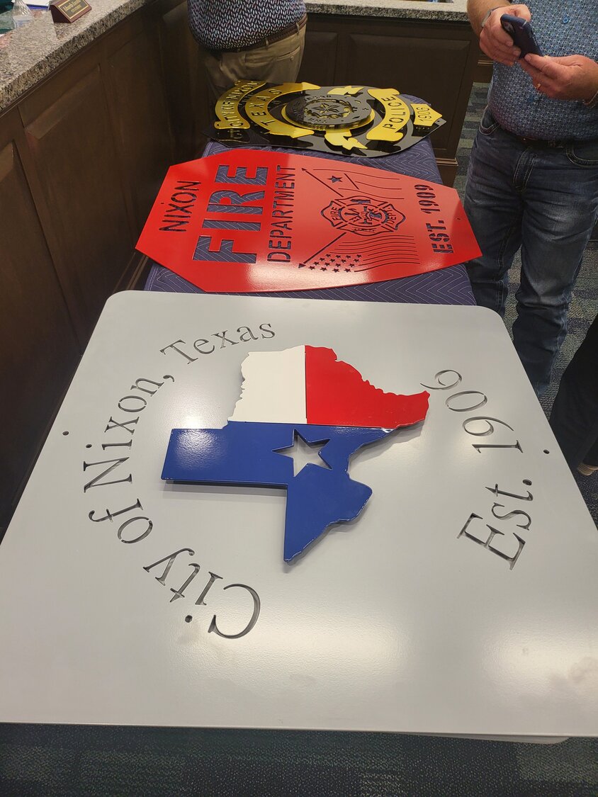 Powder-coated signs saluting the City of Nixon, the fire department, the police department and the Nixon-Smiley Mustangs (not shown) will be placed on limestone blocks or a wall at the intersection of US 87 and Texas 80 in front of Dairy Queen as a new city monument.