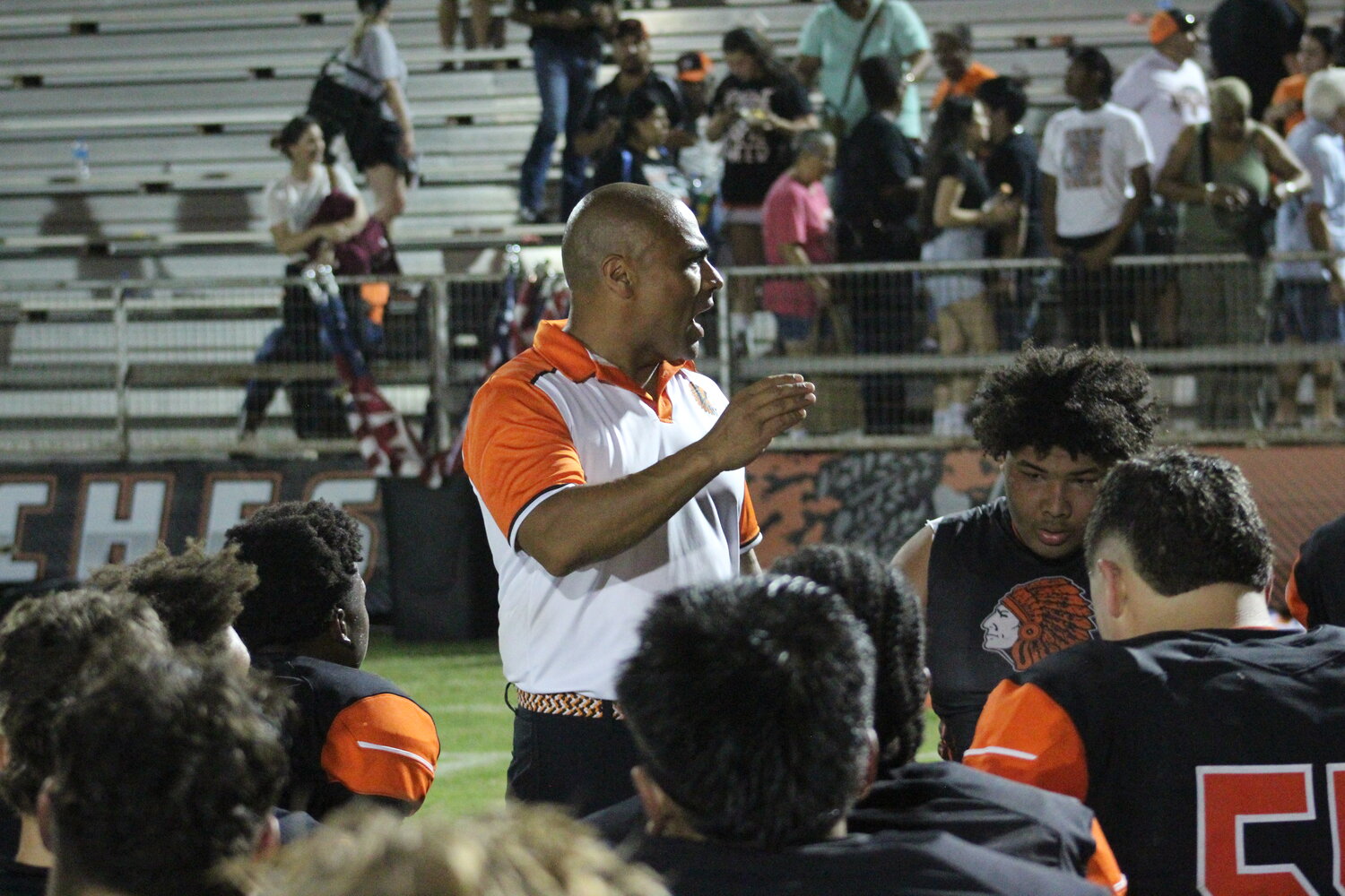 Apaches head football coach Joey Rivera speaks with his players after the win over Pleasanton Friday, Sept. 20