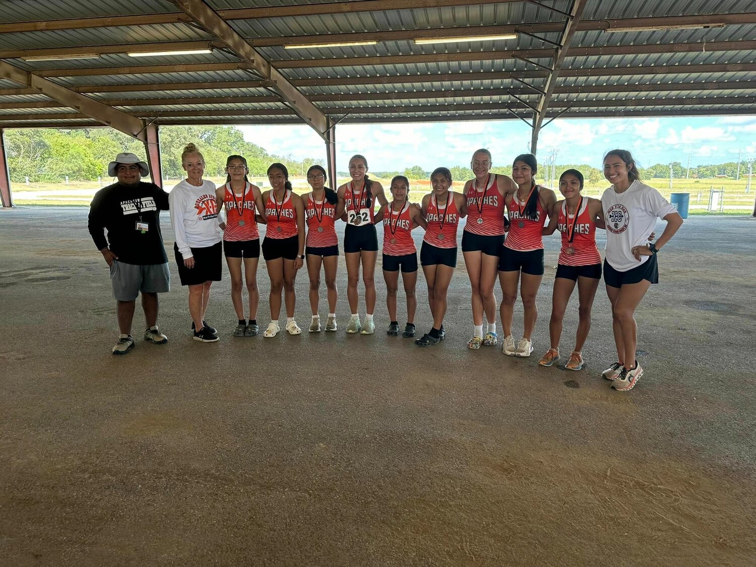 The Gonzales Lady Apaches cross-country team with their coaches for the home at JB Well Saturday, Sept. 21.