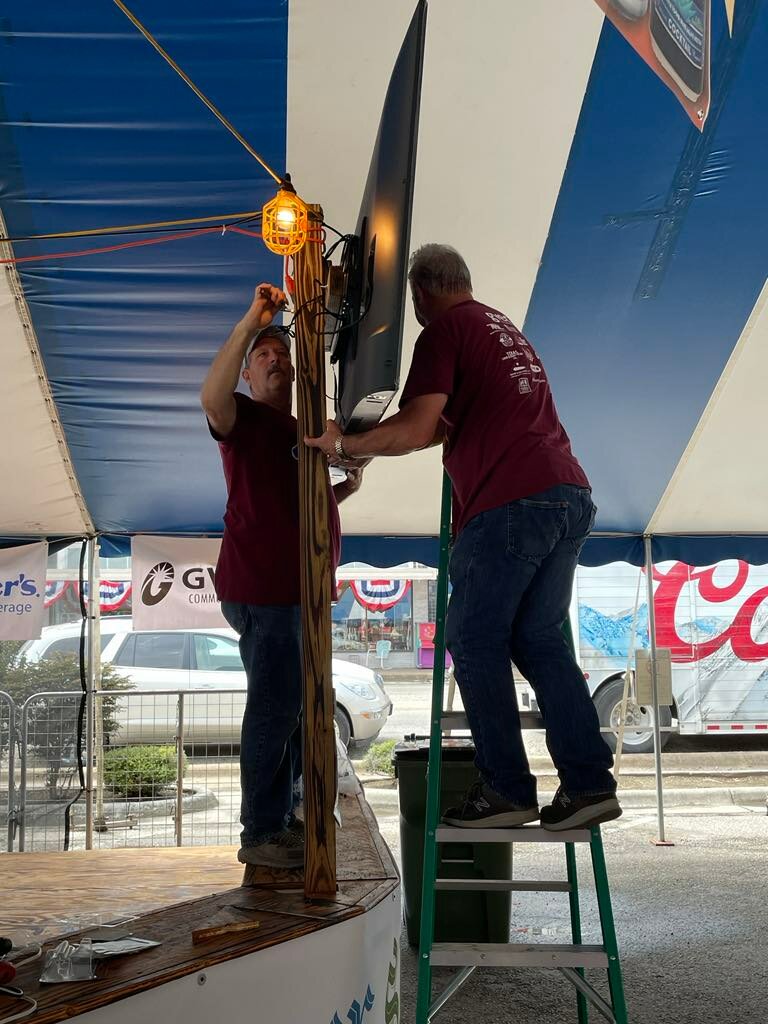 Volunteers with the Come and Take It Committee setup TVs in the beer tent so those at the festival can keep up with college and pro football games while also enjoying a cold one.