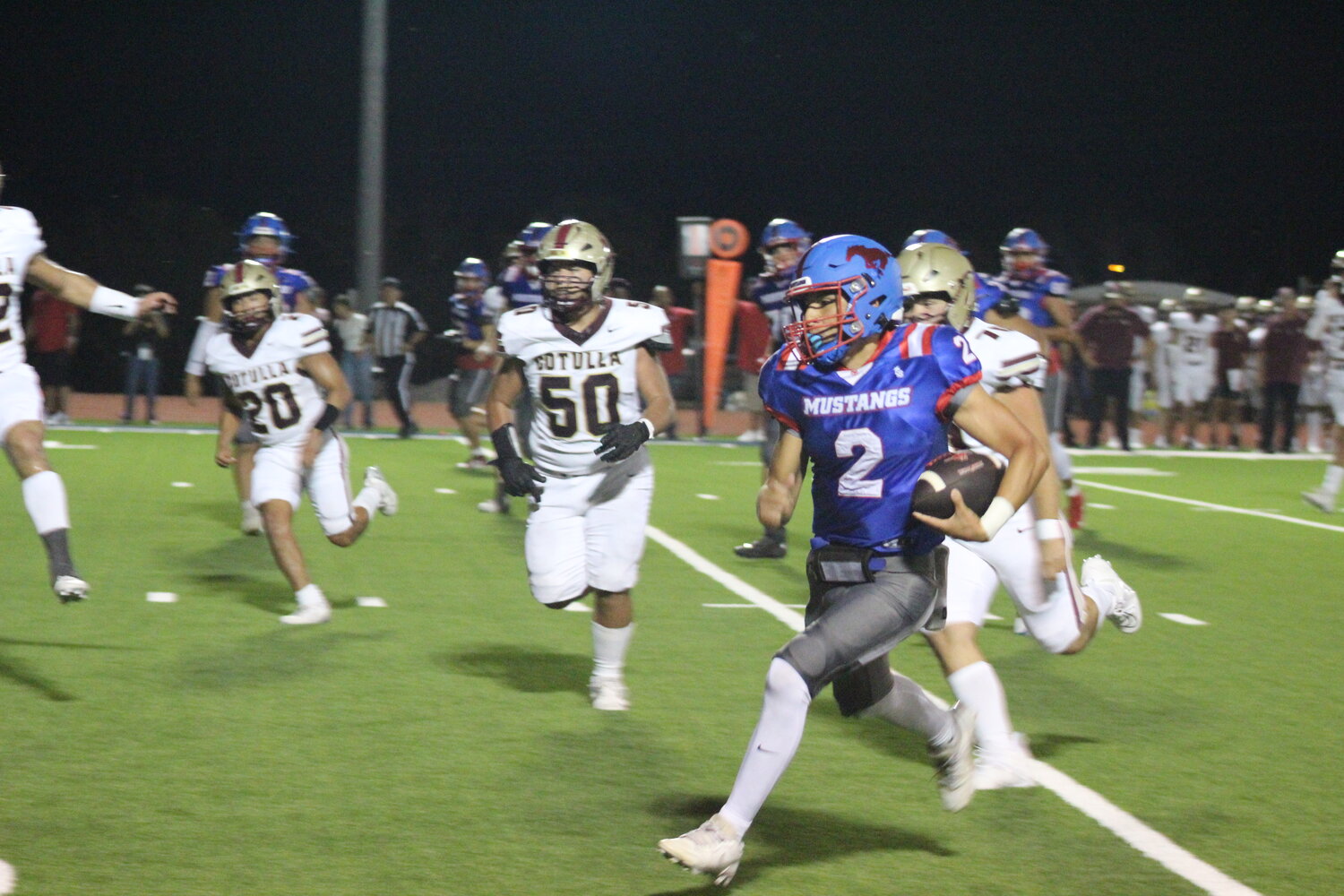 Nixon-Smiley sophomore quarterback Eric Rodriguez (2) runs for positive yards for the Mustangs against Cotulla Friday, Sept. 27.