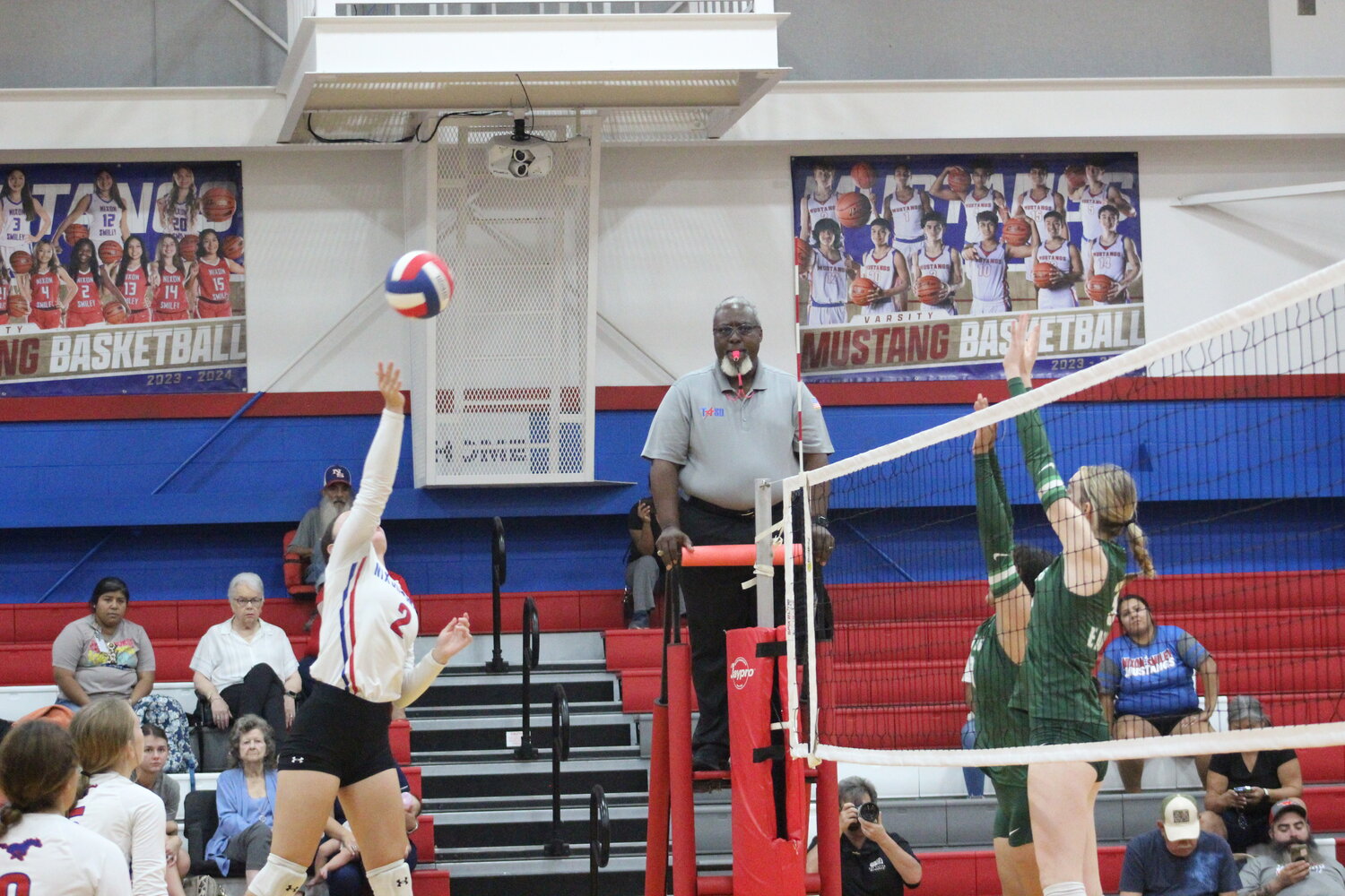 Lady Mustangs senior Hailee Houseton (2) spikes the ball in the air against the Luling Lady Eagles Tuesday, Oct. 1.