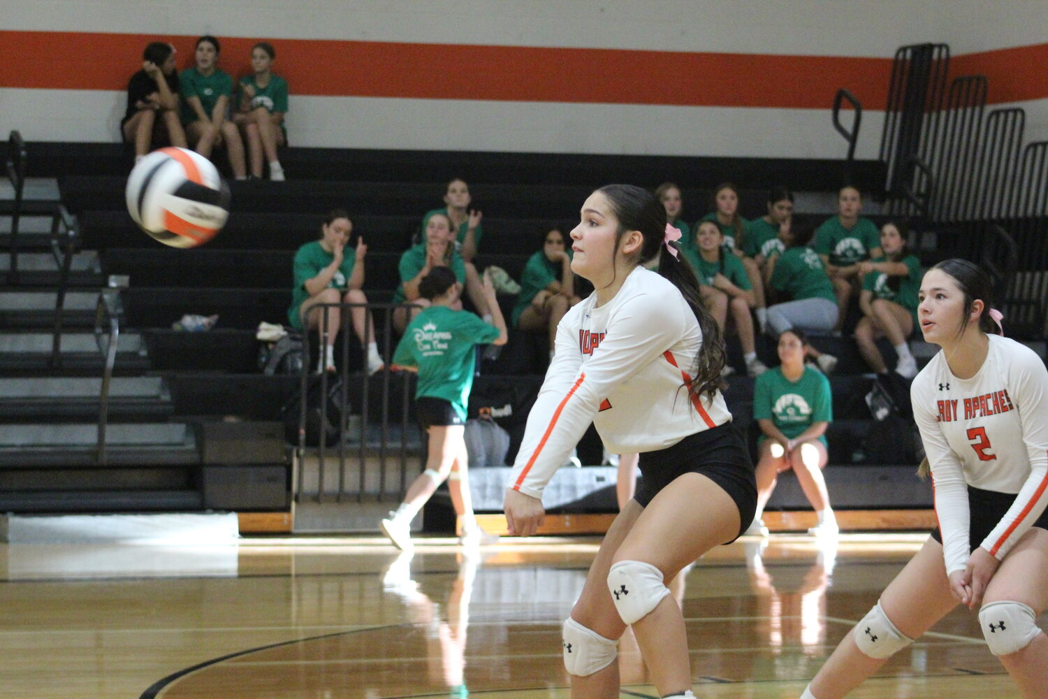 Lady Apaches freshman defensive specialist Carsyn Carrizales (13) records a dig in the district match against Cuero.