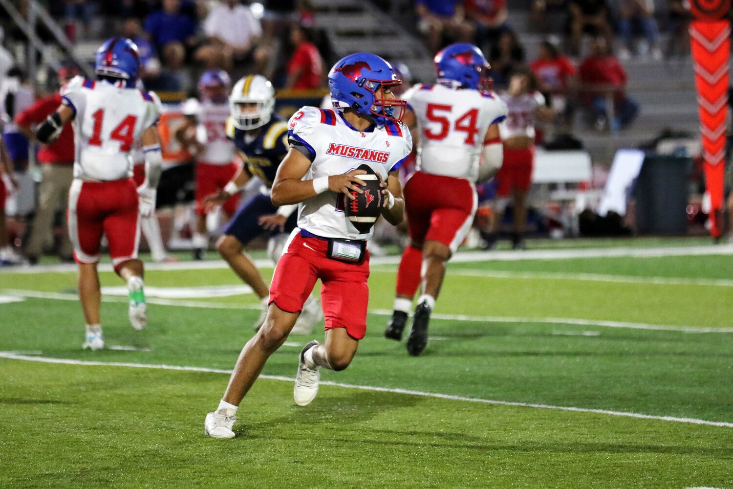 Mustangs quarterback Eric Rodriguez (2) surveys the field for an open receiver in the district game against Poth.