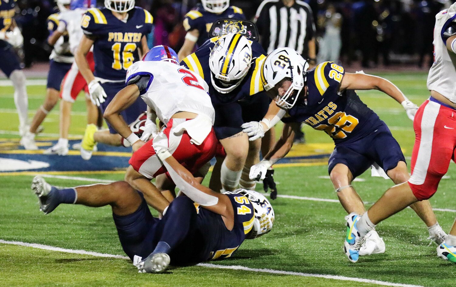 Nixon-Smiley sophomore 
quarterback Eric Rodriguez (2) gets tackle down by three Poth defenders.