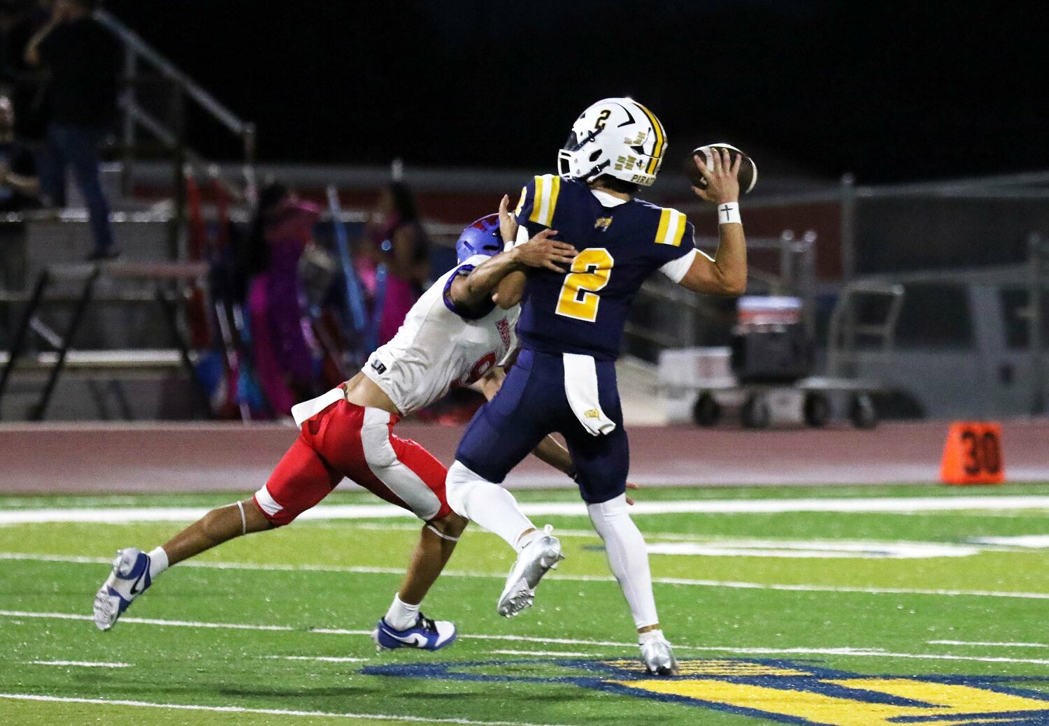 Mustangs senior linebacker John Garza applies pressure on Poth junior quarterback Major Luna (2).