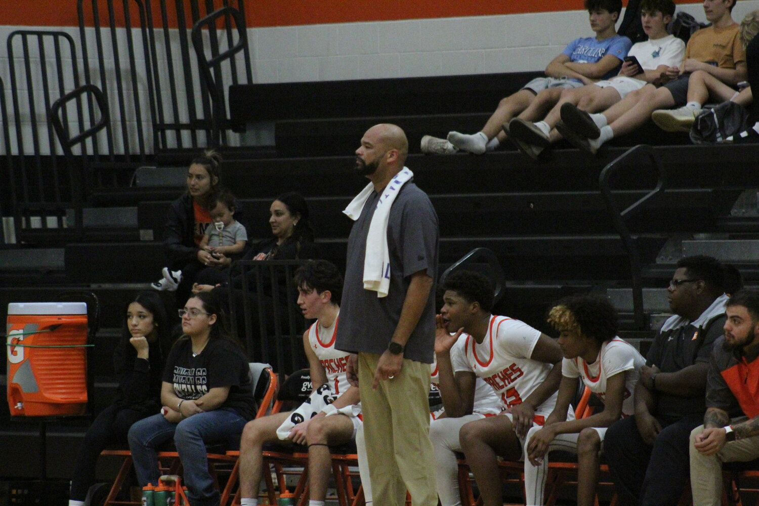 Apaches head basketball coach Steven Pinchback on the sideline with his team in the game against Wimberley.