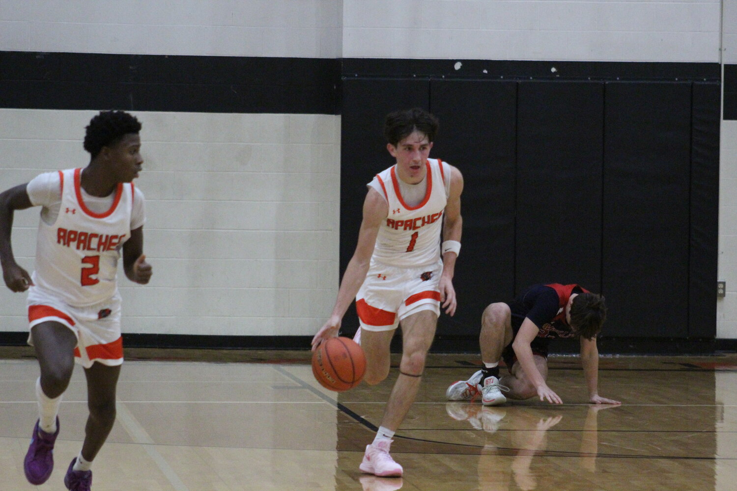 Apaches senior guard Gavin Lekgega (1) moves the ball down court after a steal from a Wimberley player.