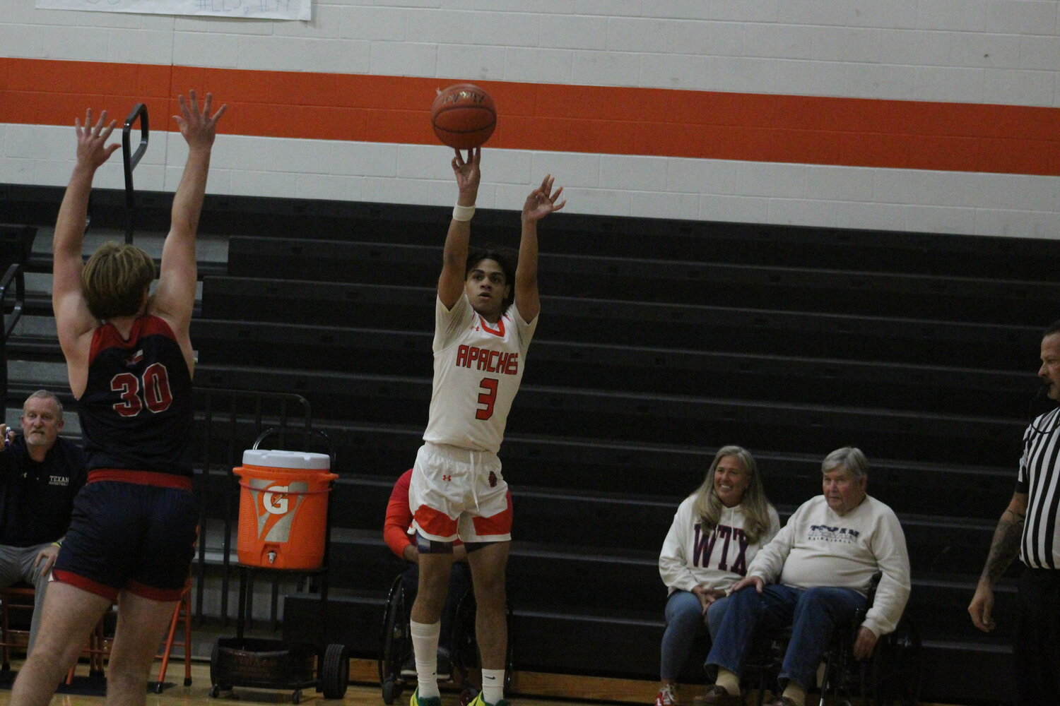 Apaches senior guard Jzyah Melancon (3) shoots a corner three against Wimberley Tuesday, Dec. 3.