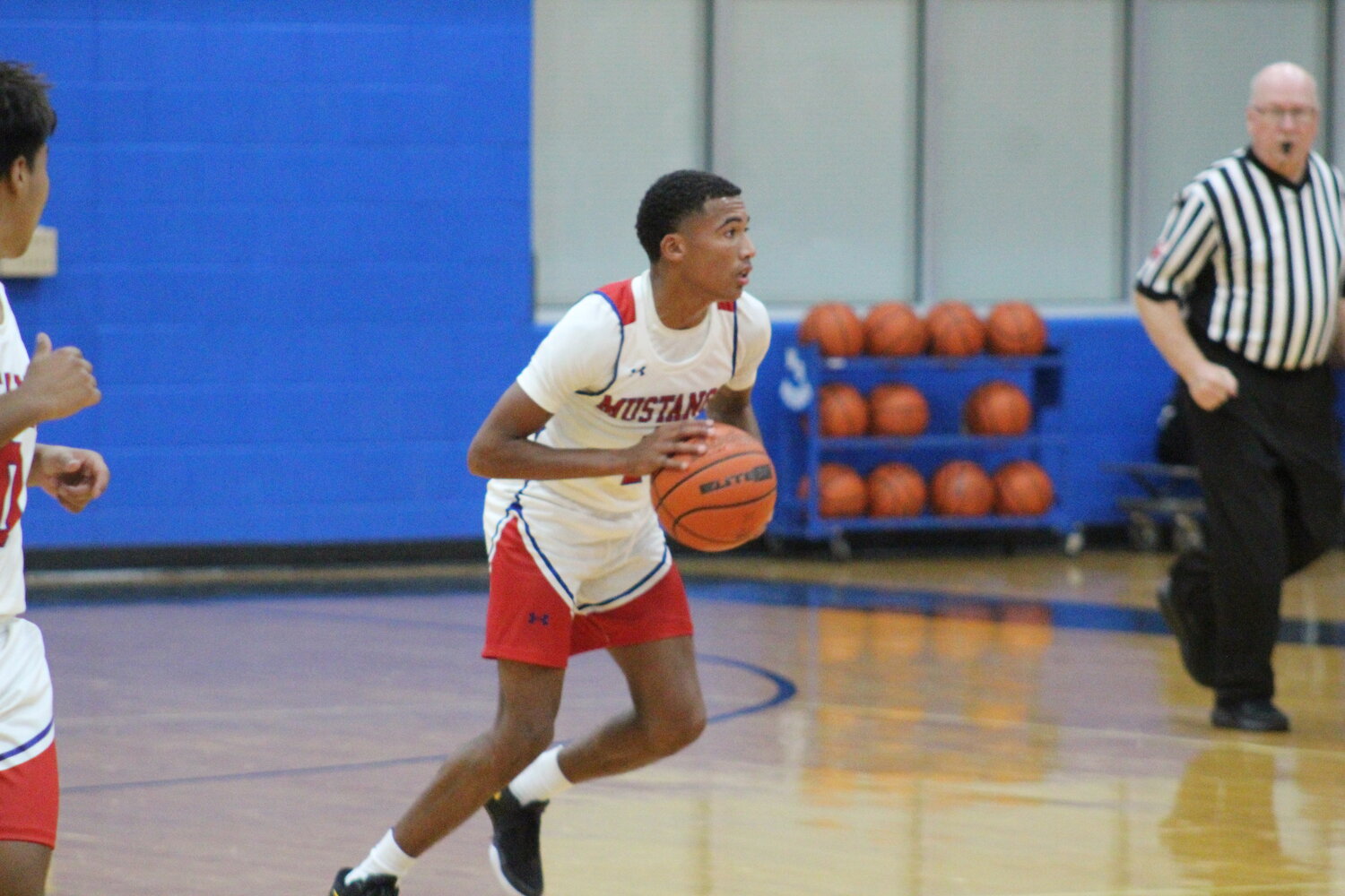 Mustangs senior guard Tristen Mikesh moves the ball on his home court in Nixon-Smiley High School earlier this season.