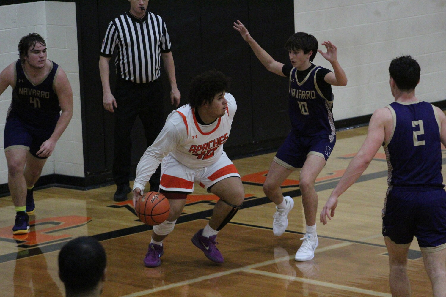 Apaches senior center Dylan Hunt (40) dribbles the ball around three Navarro defenders in the non-district game Tuesday, Dec. 17