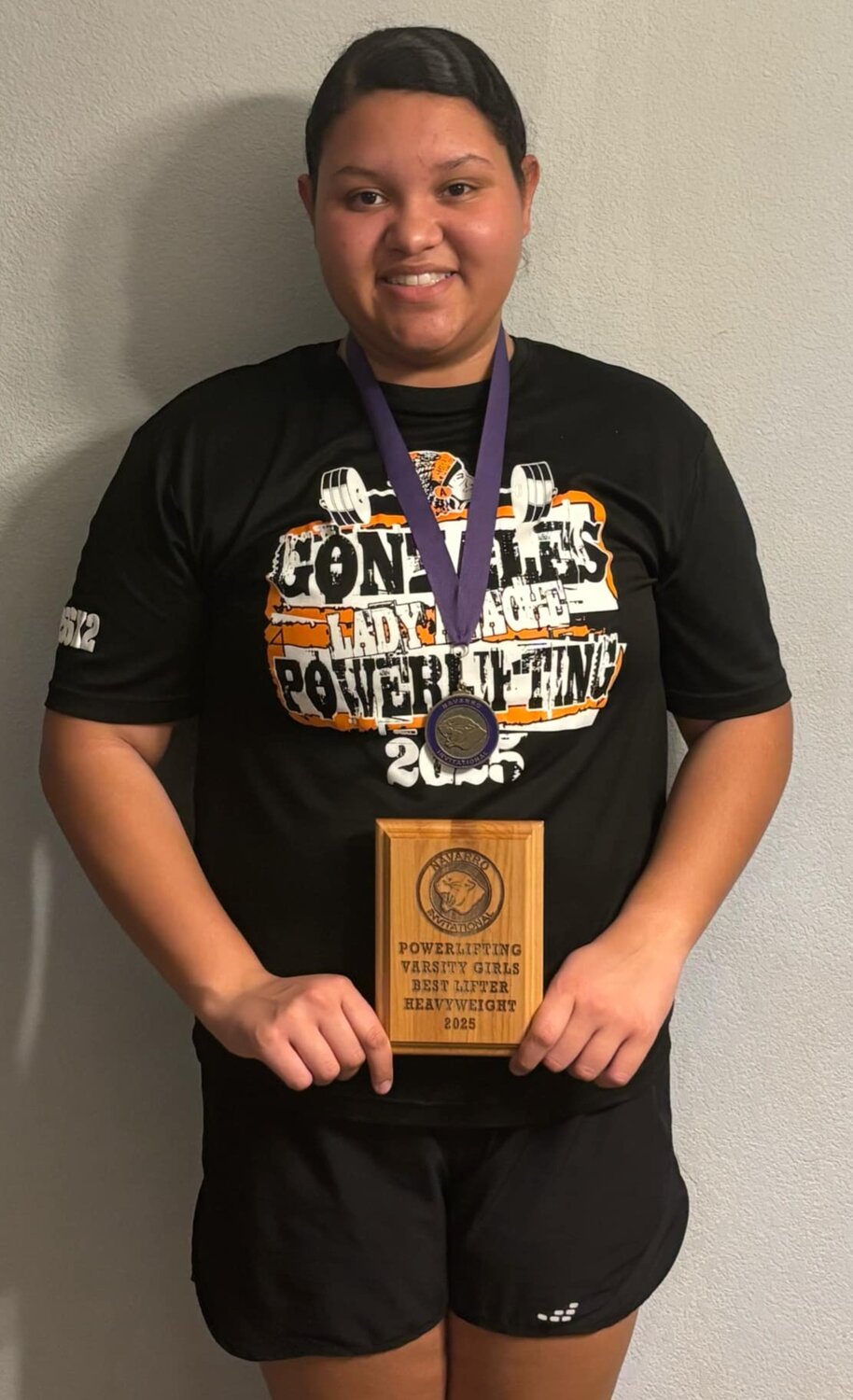 Lady Apaches senior Madison Sampleton holds her best lifter plaque from the Navarro meet.