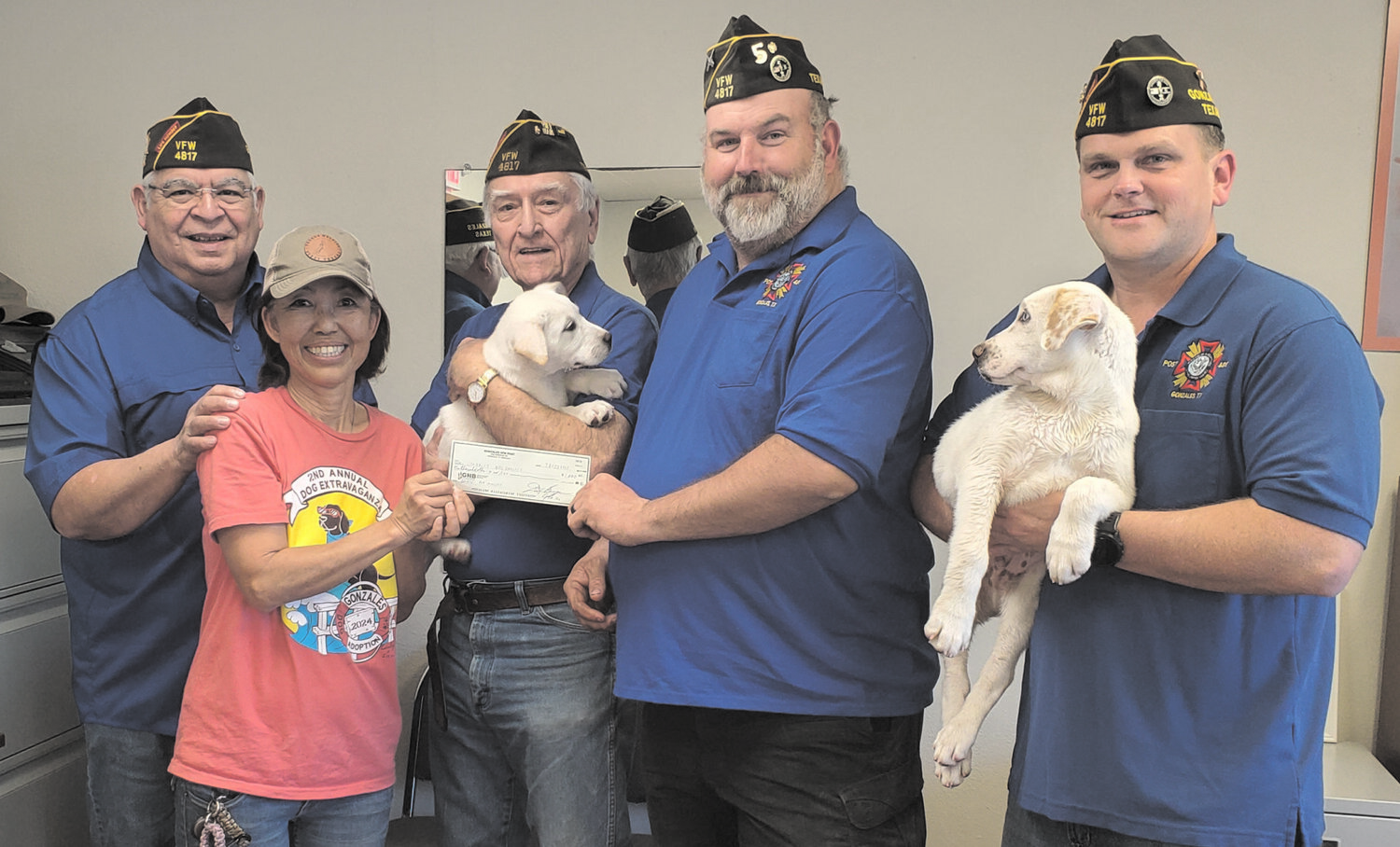 From left, Andy Rodriguez, Gonzales Dog Adoptions Representative Keiko McCormick, Dick Kuenzler, VFW Post Commander David Burger, John DuBose, and two available-for-adoption puppies from the shelter.