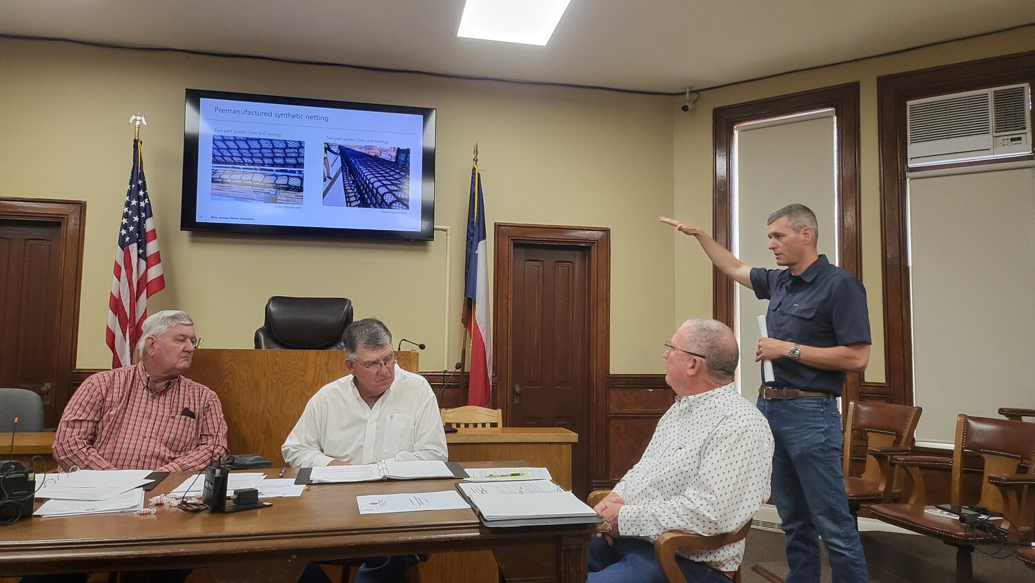 ohn Duke of CPM speaks to Gonzales County commissioners about the findings by Wiss, Janney, Elstner Associates (WJE) engineering firm regarding the facade at the Randle-Rather building downtown.