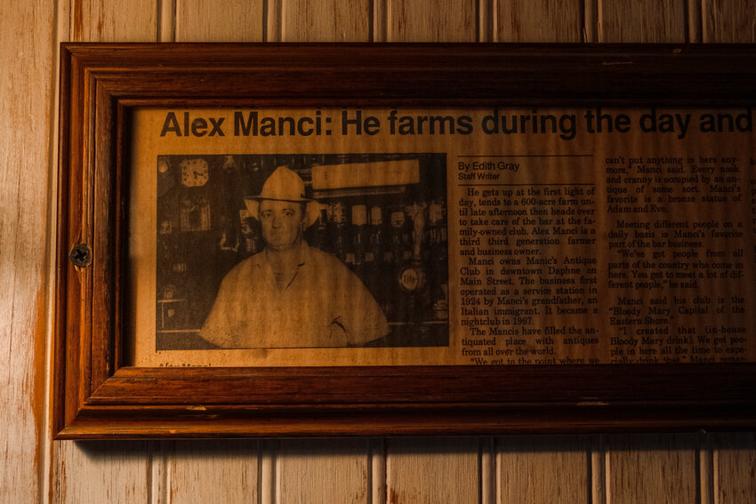 A photo of Alex Manci hangs at Manci’s Antique Club in downtown Daphne. The building is celebrating its 100th year of operation.
