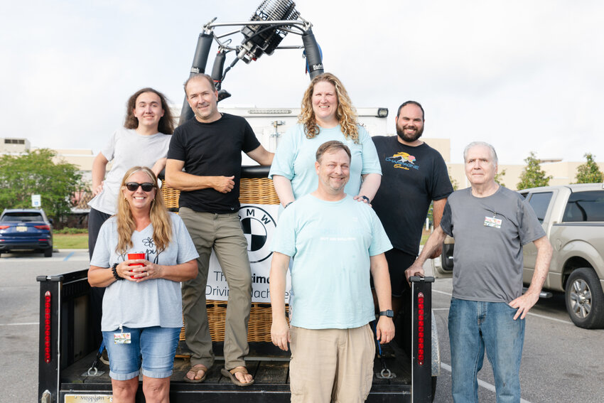 From back left: Devin Poole, Fred Poole, Karin Miller and Ben Eakes. From front left: Lori Poole, Eric Kiehle and Charles Poole all stand in front of hot air balloon pilot Fred Poole's basket.