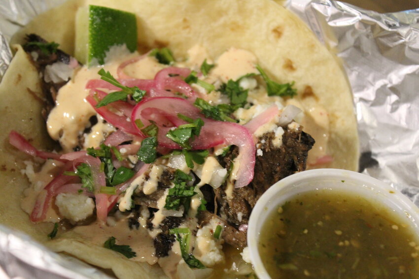 The shredded beef taco was topped with cilantro, pickled onions, queso fresco, sauce Hermanos and a lime wedge.