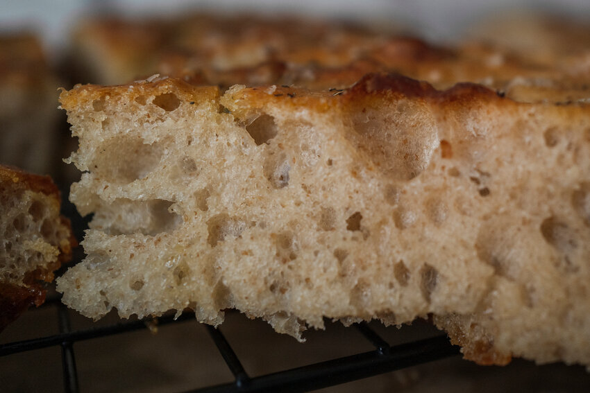 MICAH GREEN / GULF COAST MEDIA
Sea salt and herb sourdough focaccia. Lindsey Sholes at the first brick and mortar for Black Cat Bakery inside the same building as Cheeseburger Randy’s.