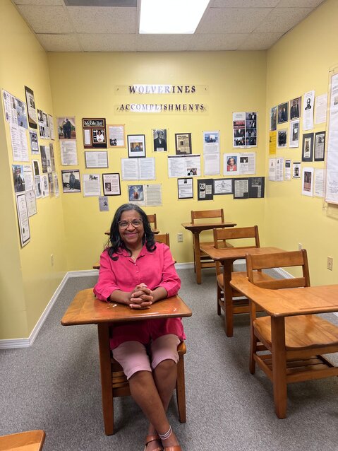 Vickie Graham sits in a desk at the Black Education Museum in Daphne as she reminisces about May Day at Anna T. Jeannes and Baldwin County Training School.