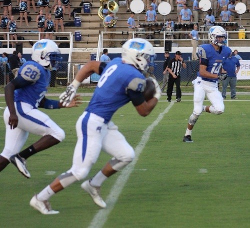 John Sherill (8), returns a kickoff flanked by Tanner Deeds (14) and Darnell Bell (28).
