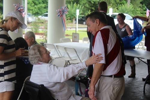 Tom Boyington greets a veteran at the American Heroes Memorial Day Cookout at the William F. Green State Veterans Home in Bay Minette on Monday.