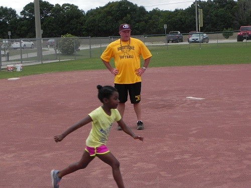 RHS head softball Coach Barry Roberts oversees base running drills during the free city camp held this past week.