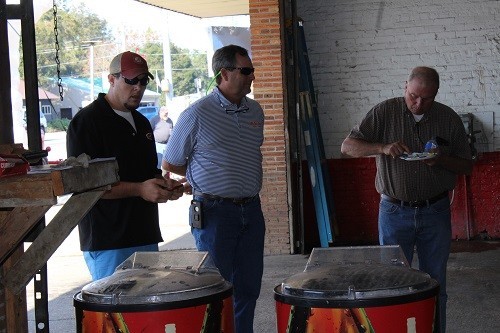 Sweat Tire owner Dewane Hayes and Bay Minette manager  Cruze Daigre greet a customer at Sweat Tire in Robertsdale on Dec. 1.