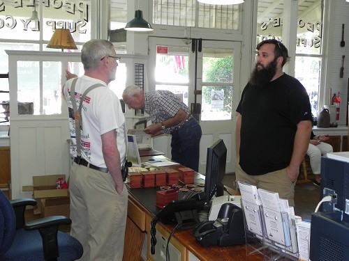 Peco Forsman speaks to a Heritage Day attendee at United Bank (historic People&rsquo;s Supply). He also gave a presentation at the Silverhill Covenant Church.