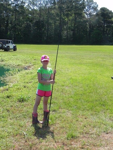 Elizabeth D&rsquo;Olive, 9, of Spanish Fort takes a break from fishing on Saturday, May 12 in Loxley.