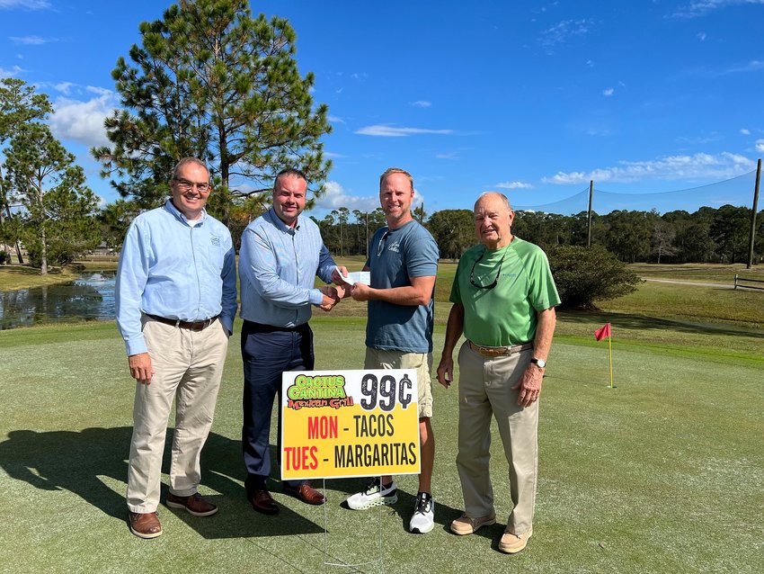 Ernie Culpepper of Georgia won $250 for a hole-in-one on Hole 3, sponsored by Cactus Cantina, at the Orange Beach Golf Center&rsquo;s November Skins Game. From left are City Administrator Ken Grimes Jr., Culpepper&rsquo;s friend Christopher Dismuke who accepted it on his behalf, Caucus Cantina owner Bobby Wade and Skins Game committee member John Hulen.