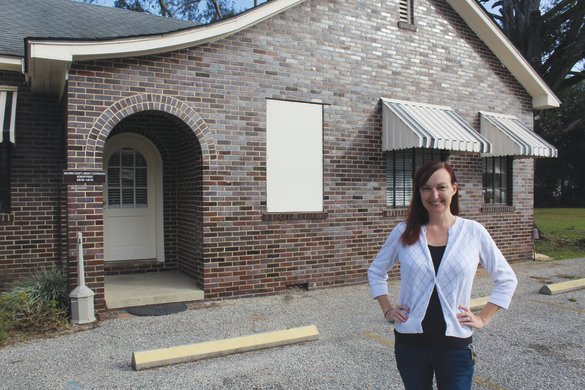 Baldwin County Library Cooperative Director Elizabeth Webb stands in front of the library's new facility in Loxley.