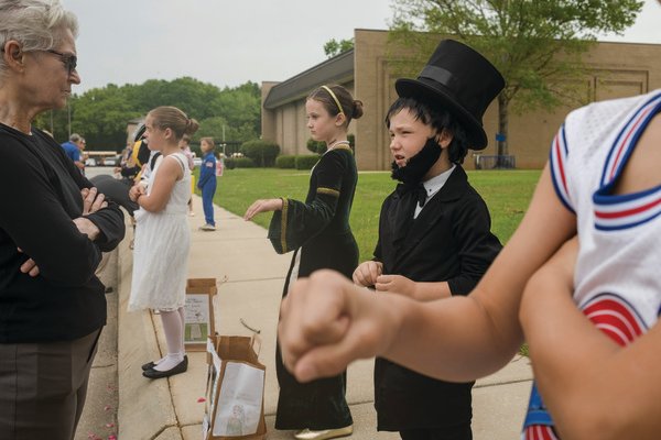 Dressed as Abraham Lincoln, Aiden White, a 2nd grader in Kelly Hayes&rsquo; class at Fairhope East Elementary, tells a Wax Museum patron about Lincoln&rsquo;s life.