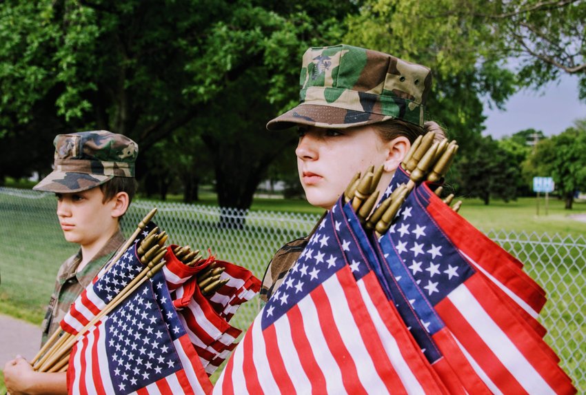 YM/Pvt. T.E. Hallowell and YM/Pvt. J. Anderson from the Tornado Alley Young Marines in Wichita, Kansas. Young Marines placed flags in memory of veterans on Memorial Day 2019.