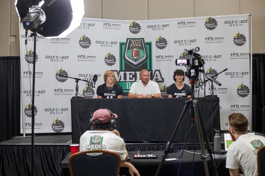 The Elberta Warriors, represented by athlete Holden Crook, head coach Nathan McDaniel and quarterback Hunter Powers, were one of the local football teams that made their way through the Orange Beach Event Center Tuesday, Aug. 16, for the inaugural Gulf Coast Media Day.