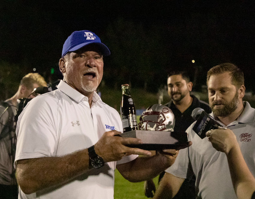 Bayside Academy head coach Phil Lazenby hoists the Dr. Pepper trophy the Admirals received for taking down St. Michael Catholic 17-14 to open region play Sept. 2 on Freedom Field in Daphne. Bayside Academy&rsquo;s win last Friday secured Lazenby&rsquo;s 200th for his career.