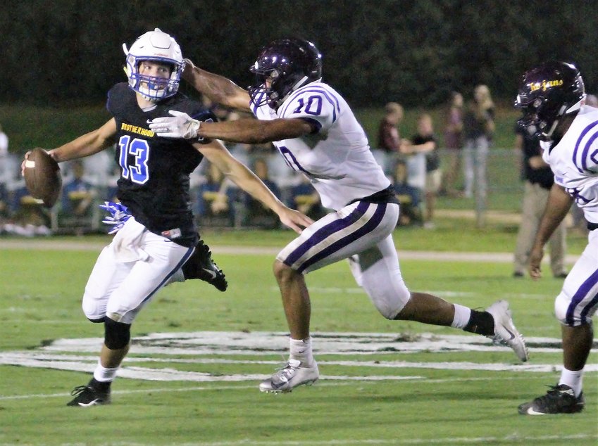 Fairhope quarterback Riley Leonard attempts to escape pressure from Daphne&rsquo;s Ronnie Cleveland during the region game between the Pirates and Trojans Sept. 28, 2018, on W. C. Majors Field. Leonard, now the quarterback for the Duke Blue Devils, will look for a second win in as many weeks on the road in Northwestern this Saturday.