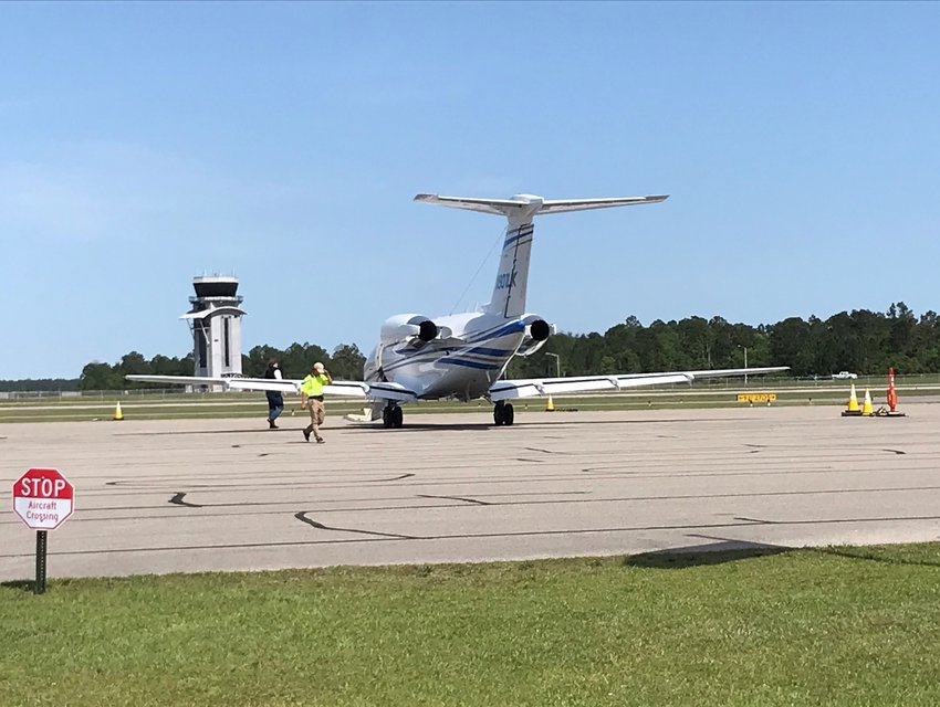 Passengers board a jet at the Gulf Shores International Airport.