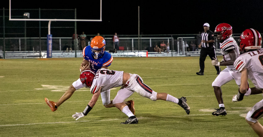 Orange Beach senior John Wallace Holladay is met by T.R. Miller senior Sam Kelley in the second half of the Makos&rsquo; home region game against the Tigers Friday night. T.R. Miller won 38-13.