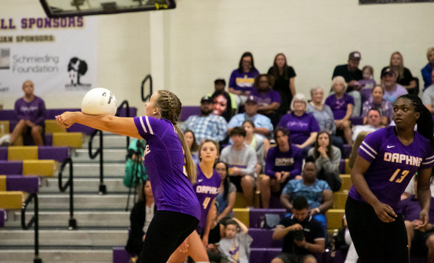 Daphne junior setter Lucy McCoy bumps a pass during the Trojans&rsquo; area match against the McGill-Toolen Yellow Jackets Tuesday, Sept. 20, at home. McCoy recently surpassed 1,000 assists as a Daphne Trojan.