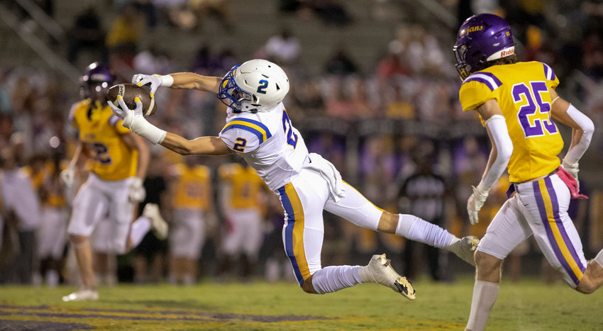 Fairhope senior Ben Moseley extends to haul in a catch from quarterback Caden Creel in the first half of the Pirates&rsquo; region contest against Daphne Friday, Oct. 7. Fairhope won 26-7.
